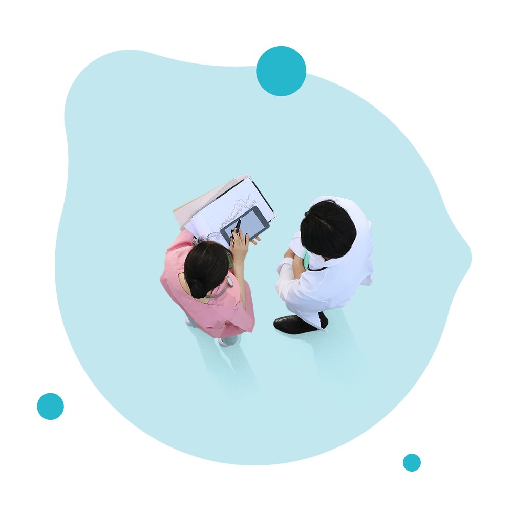 Doctors conferring on light teal background