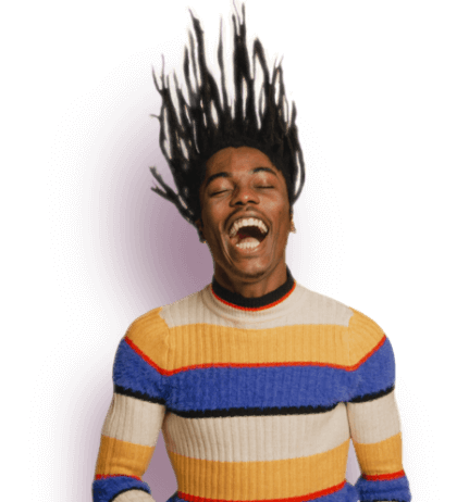 Laughing man in striped sweater throwing his hair back joyfully